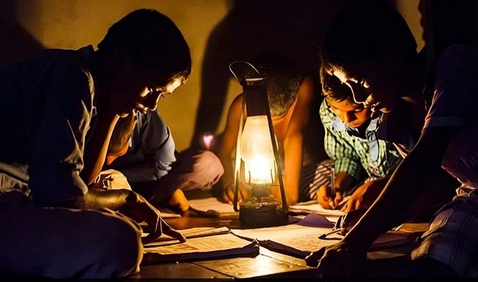Boy studying by kerosene lamp